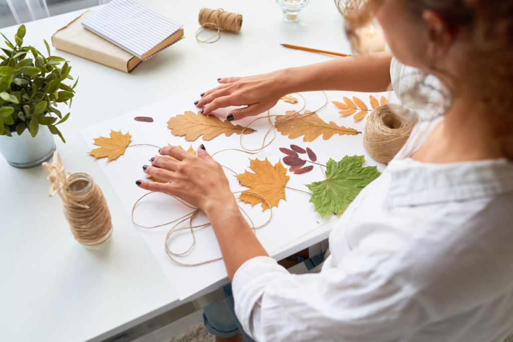 child doing handicrafts with leaves