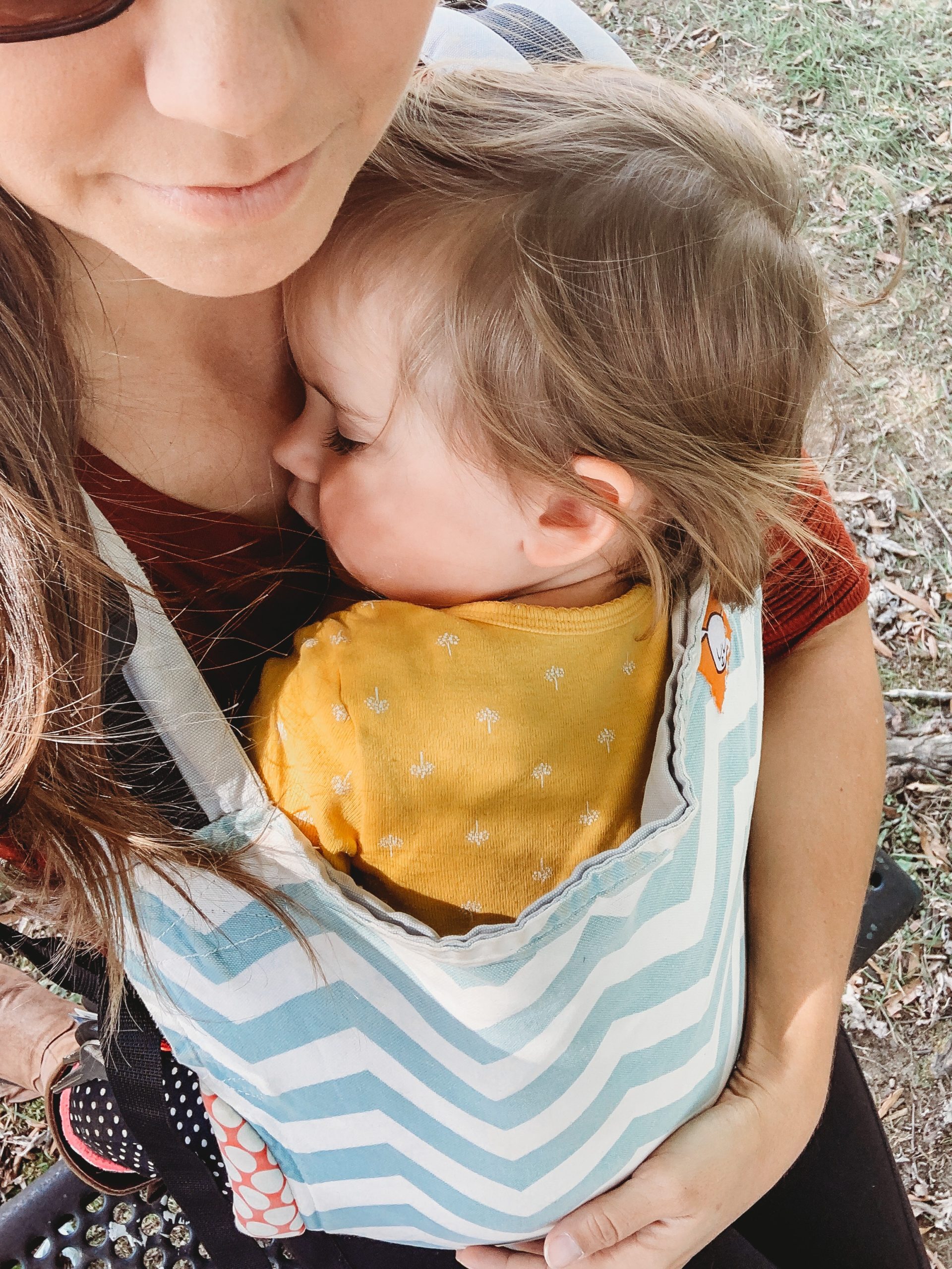 mom holding child in tula carrier