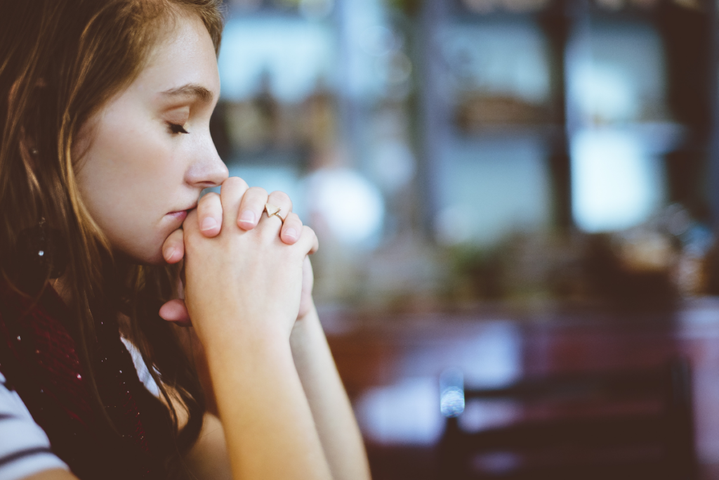 woman praying for husband